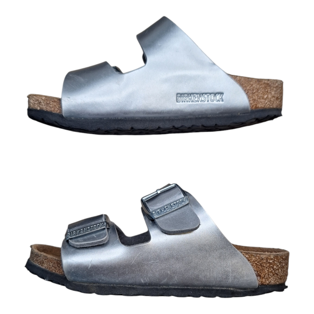 A pair of Birkenstock Arizona kids sandals, size 26. The sandals are made of gray leather with two adjustable buckles. They have a cork footbed and a black rubber sole.