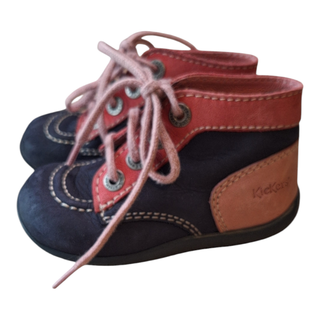 A pair of Kickers leather ankle boots, size 23. The boots are blue and red leather with pink laces and a unique rubber sole with a drawing. There are some signs of wear on the front of the boots.