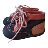 A pair of Kickers leather ankle boots, size 23. The boots are blue and red leather with pink laces and a unique rubber sole with a drawing. There are some signs of wear on the front of the boots.