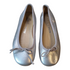 A pair of Nichols & Browne Silver Leather Ballerinas, size 30. The ballerinas are made of shiny silver leather with a light gray trim and a small bow at the toe. The interior lining is light tan.