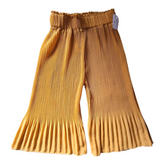 Pleated flowy yellow pants, size 104cm. The pants are mustard yellow with an elastic waistband and pleated details at the hem.