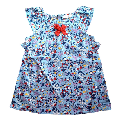 Tutto Piccolo light dress, size 74CM. The dress has a light blue background with a floral print in multiple colors and a red bow at the neckline. It has short, ruffled sleeves and a buttoned-up back.